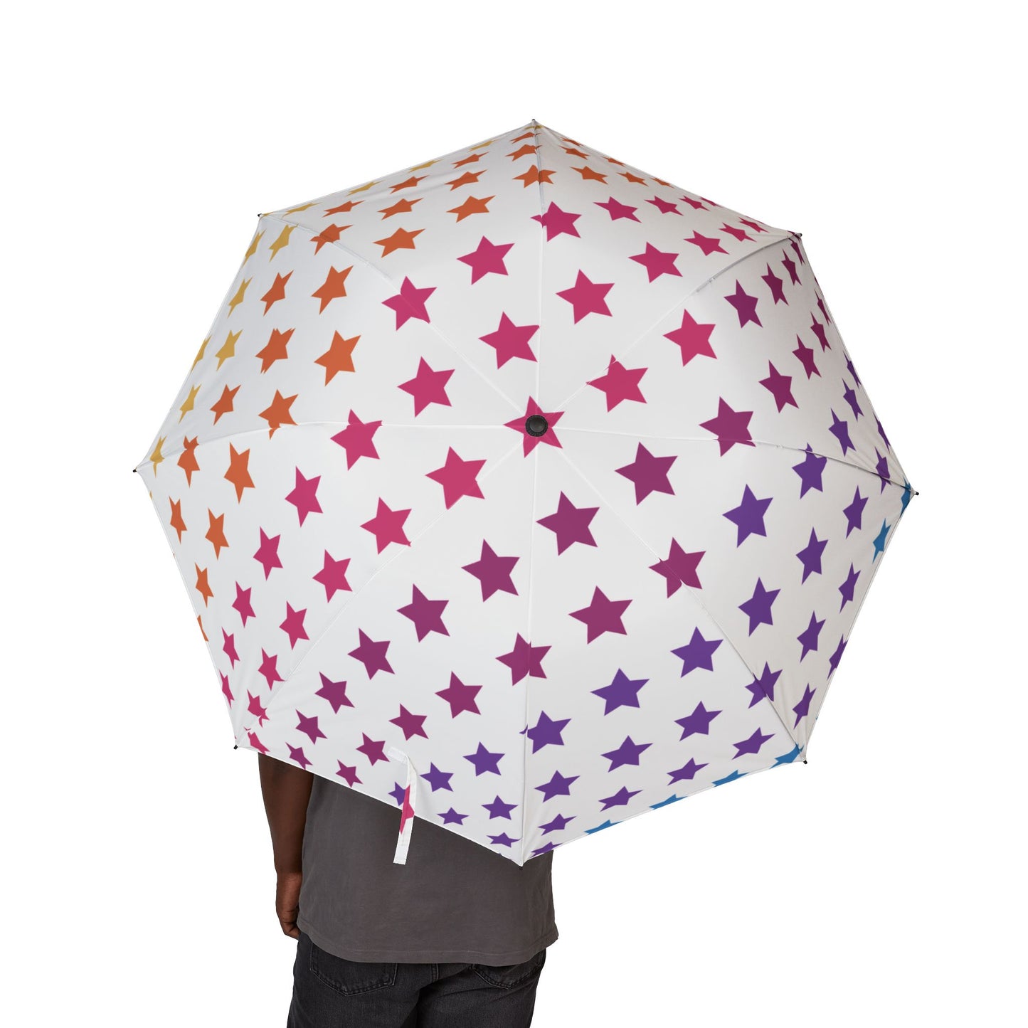 Umbrella with star pattern held by a person on a white background