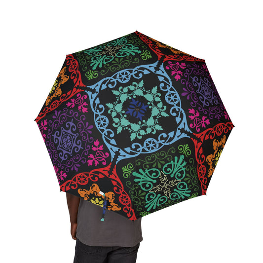 Colorful patterned umbrella held by a person on a white background