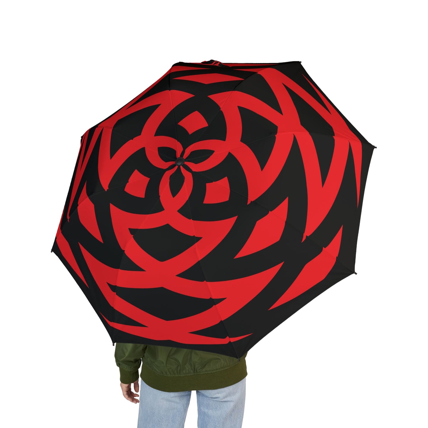 Red and black patterned umbrella held by a person on a white background