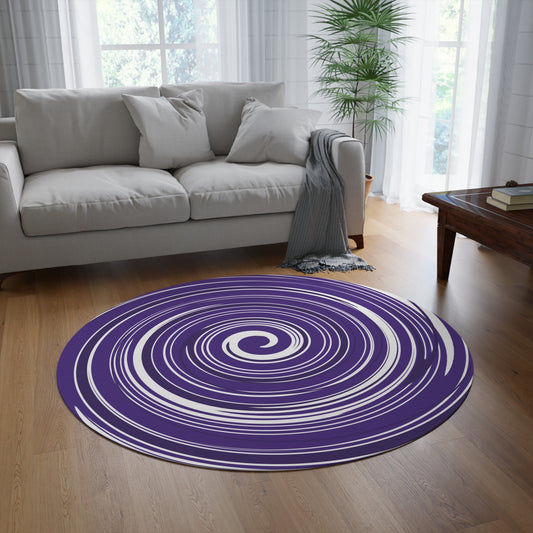 Round purple and white rug on a wooden floor in a living room with a gray sofa and coffee table.
