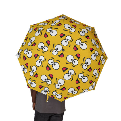 Yellow umbrella with cartoon face pattern on a white background