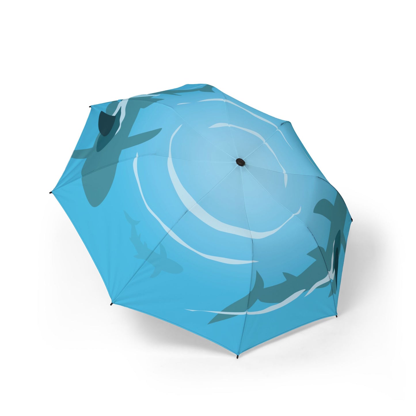 Blue umbrella with shark design on a white background