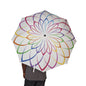 Colorful umbrella with a geometric pattern held by a person on a white background