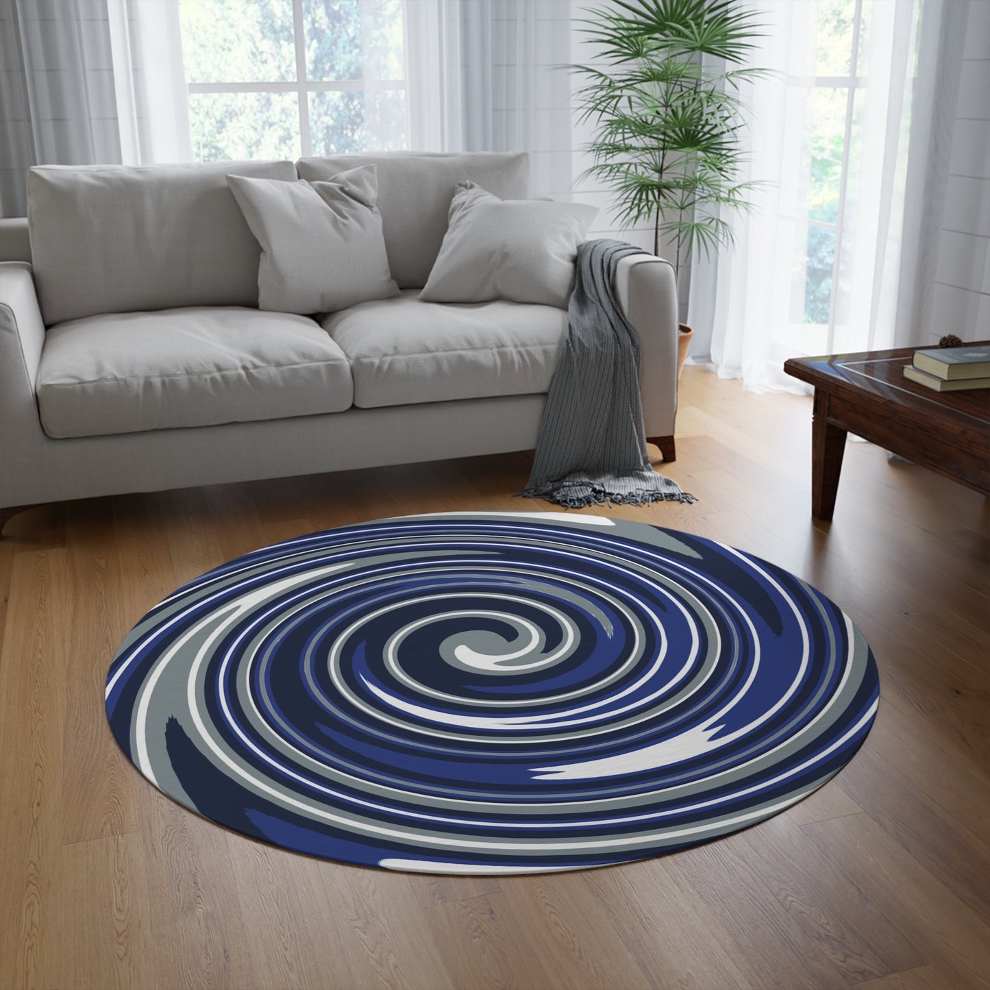 Round blue and white spiral rug in a living room with a gray sofa and wooden coffee table.