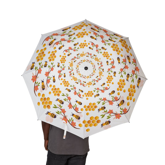 Umbrella with floral and bee pattern on a white background