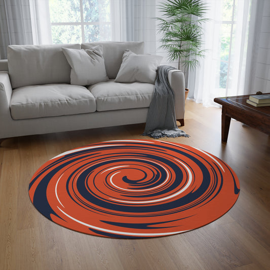 Round orange and blue rug on a wooden floor in a living room with a gray sofa and coffee table.