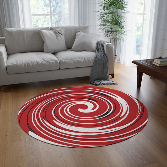 Round red and white spiral rug in a living room with a gray sofa and wooden coffee table.
