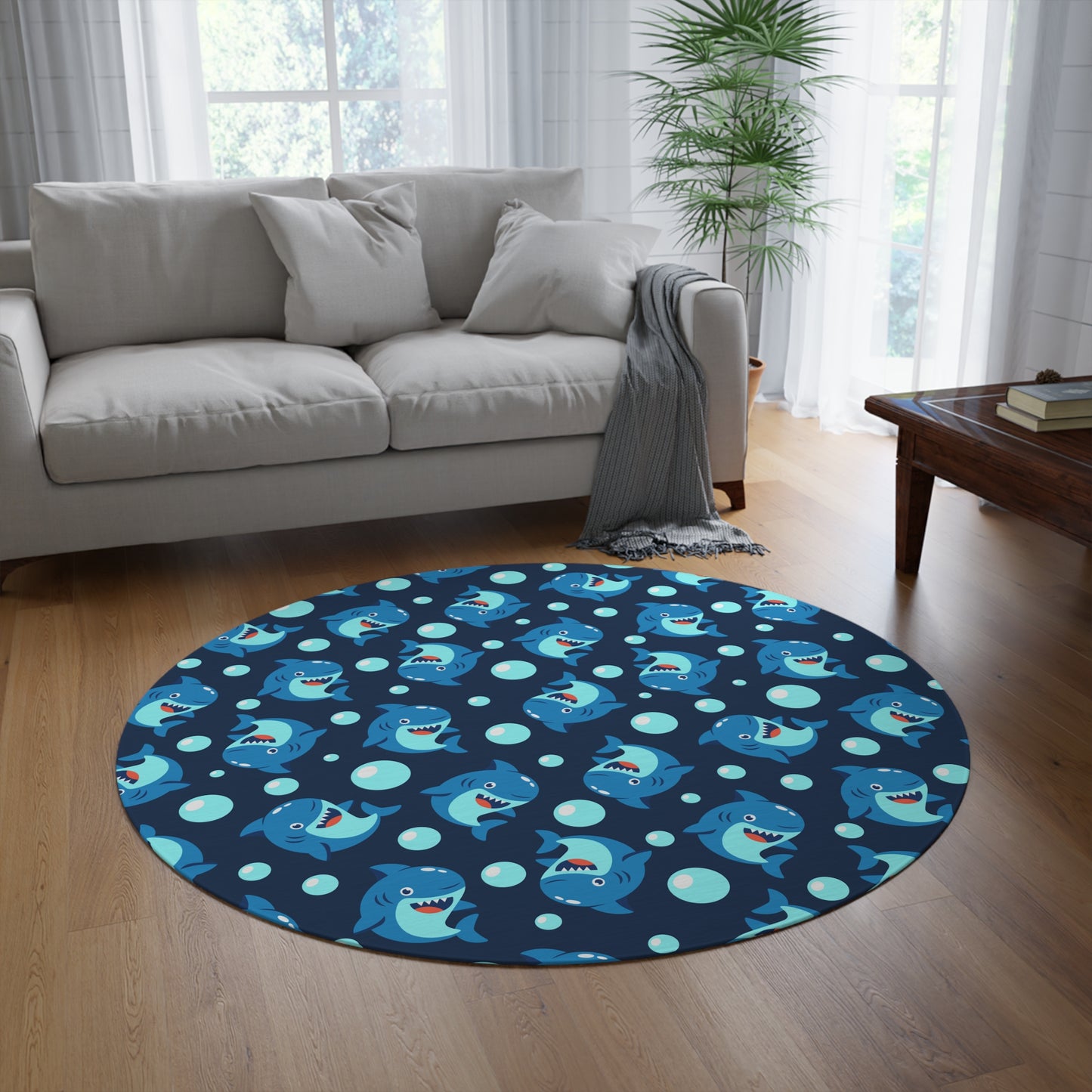 Round blue shark patterned rug in a living room with a sofa and coffee table.