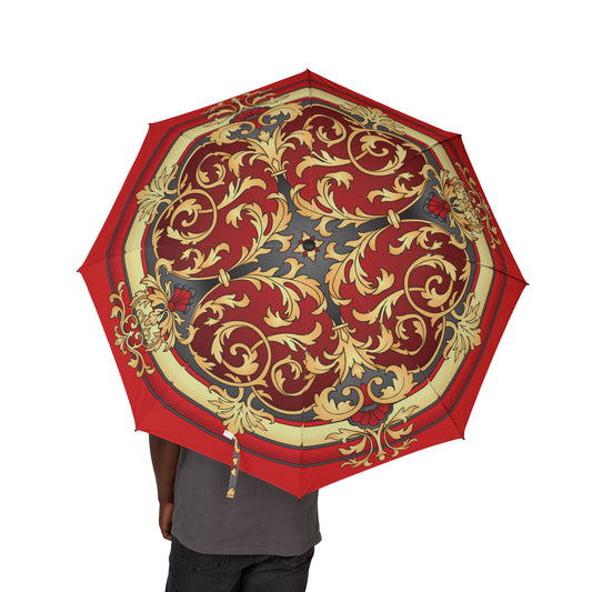 Decorative red and gold umbrella held by a person on a white background
