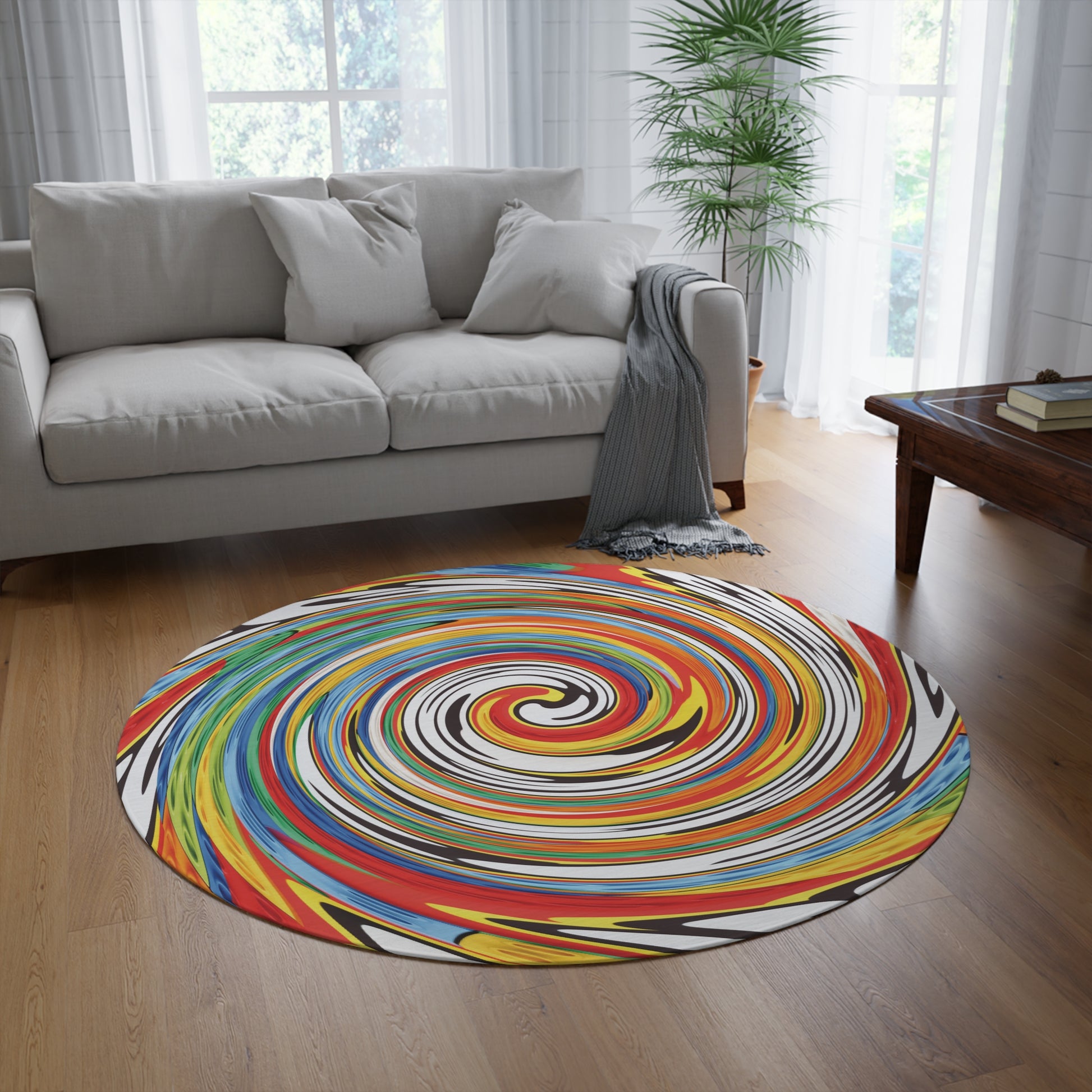 Colorful spiral-patterned rug on a wooden floor in a living room with a gray sofa and a coffee table.