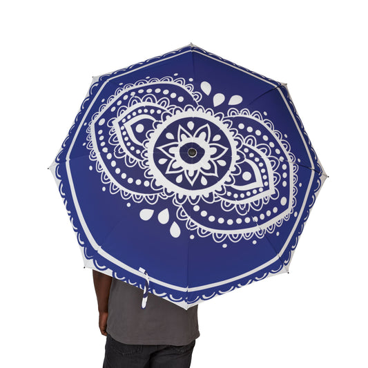 Blue umbrella with white mandala design held by a person on a white background