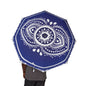 Blue umbrella with white mandala design held by a person on a white background