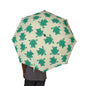 Umbrella with green frog pattern on a beige background