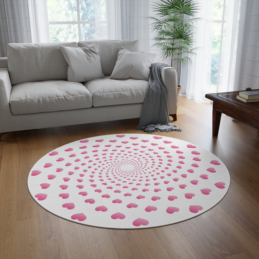Round pink heart patterned rug on a wooden floor in a living room.