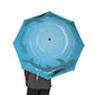 Blue umbrella with shark design held by a person on a white background